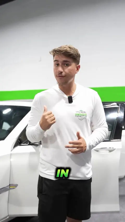 Divine Detailers explaining ceramic window tint on a white BMW