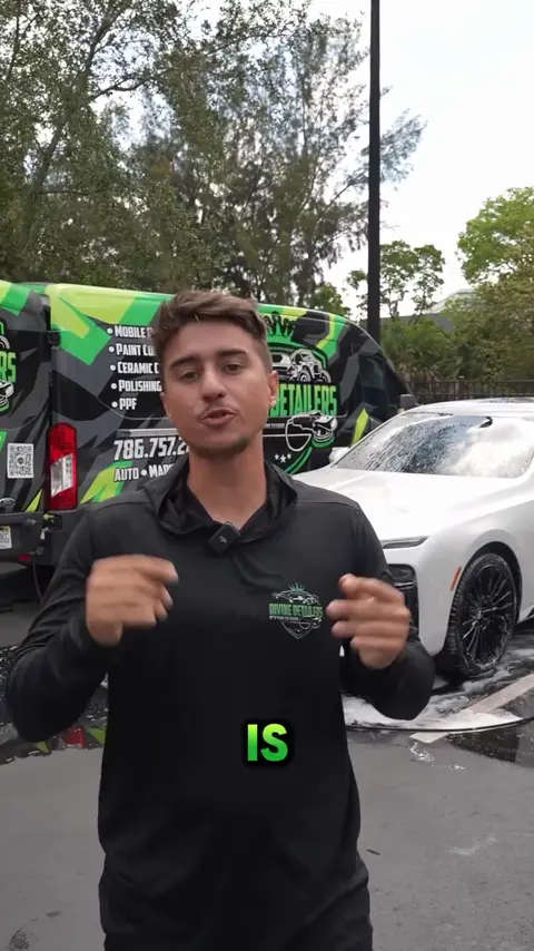 Divine Detailers explaining the signature wash package on a white BMW 7 Series