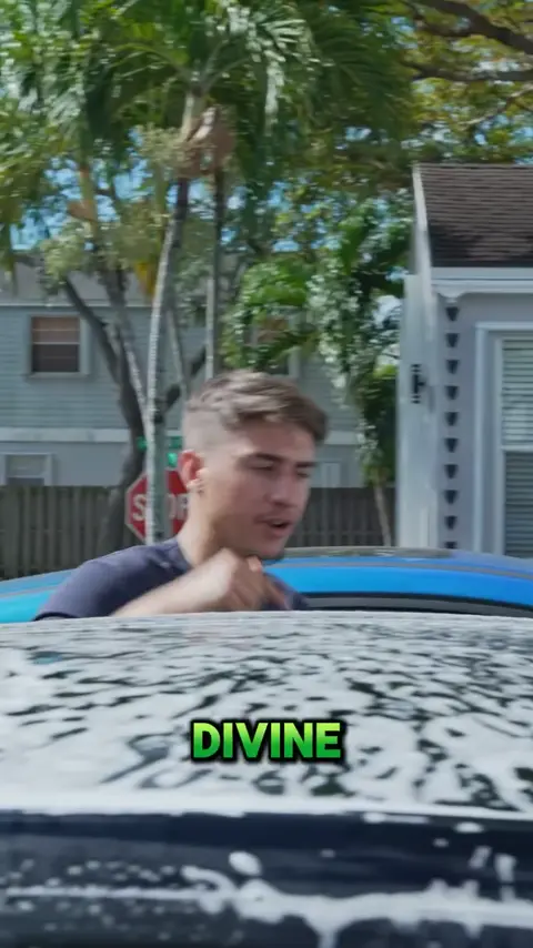 Divine Detailers explaining the signature wash and sealant on a black Tesla