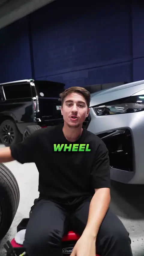 Divine Detailers explaining brake caliper and wheel cleaning on a BMW X6 M